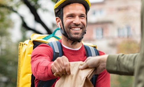 delivery-man-giving-take-away-food-DBXUQTG.jpg
