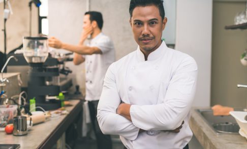 smiling-young-asian-chef-kitchen-interior